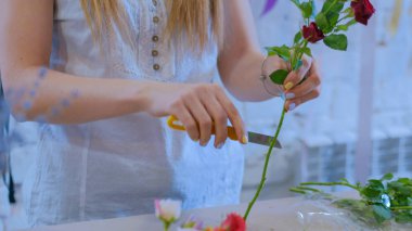 Stüdyoda çiçeklerle çalışan profesyonel bir çiçekçi.