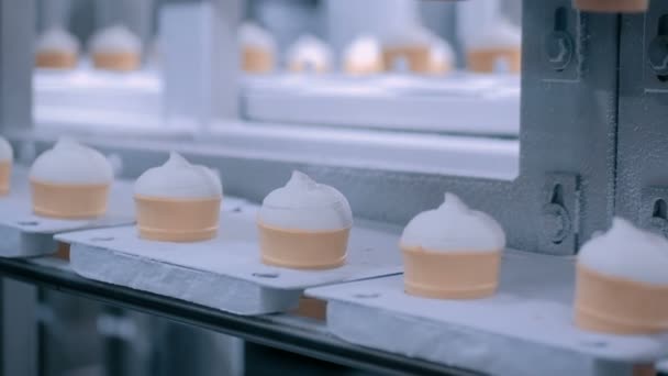 Ice cream automatic production line - conveyor belt with icecream cones — Stock Video