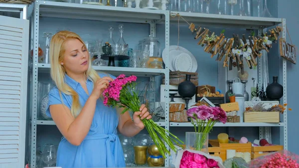 Professional floral artist sorting flowers at studio