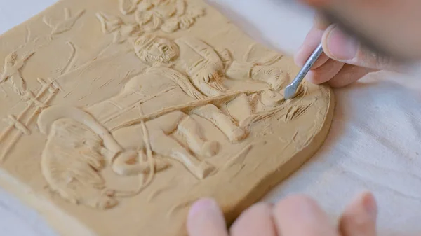 Potter making clay stamp picture