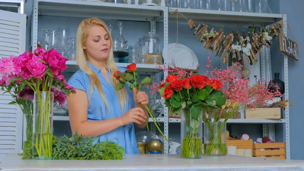 Professional florist making floral wedding composition at flower shop