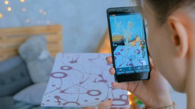 Artırılmış gerçeklik uygulaması olan akıllı telefon kullanan kadın