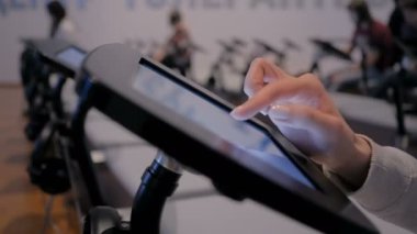 Kadın eli dokunmatik ekranı kullanarak yerde duran siyah tablet büfesi kullanıyor.