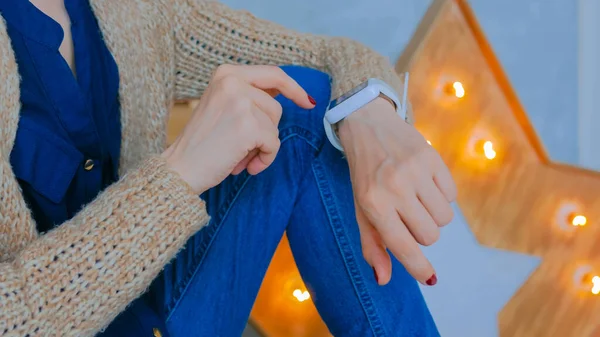 Woman using smart watch at home