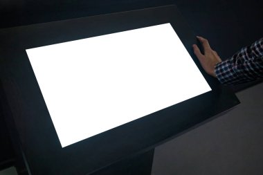 Mockup image - man looking at white blank touchscreen display kiosk
