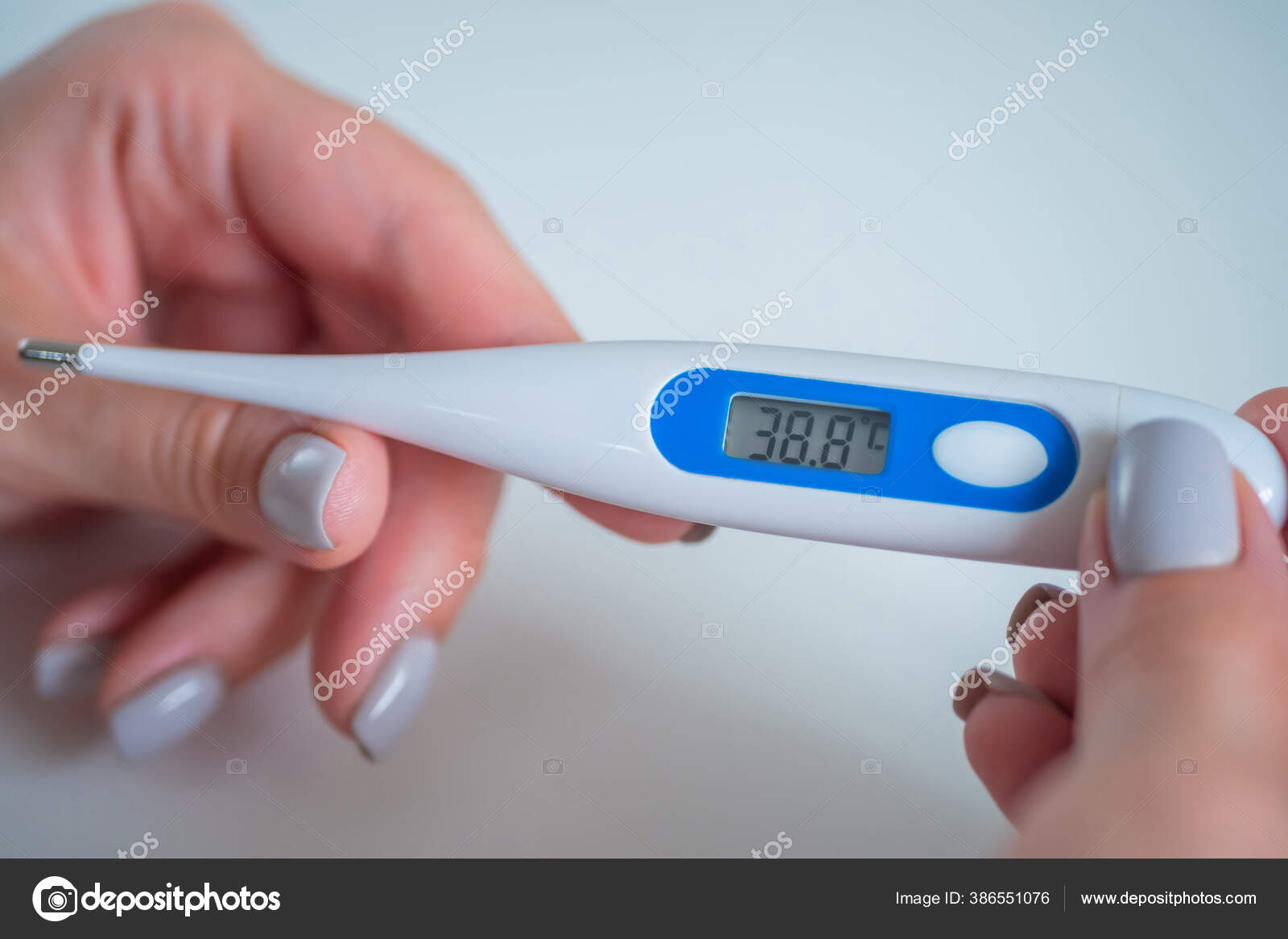 Close up: woman holding digital medical thermometer with high temperature  Stock Photo by ©Zyabich 386551076