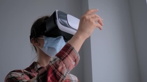 Jonge vrouw met medisch gezichtsmasker en virtual reality headset - VR concept — Stockvideo