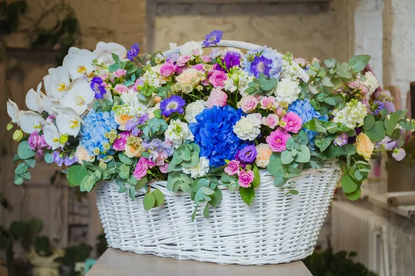 Large floral basket with flowers at flower shop
