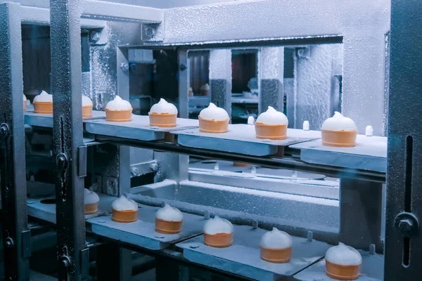 Automated technology concept - conveyor belt with icecream cones at food factory