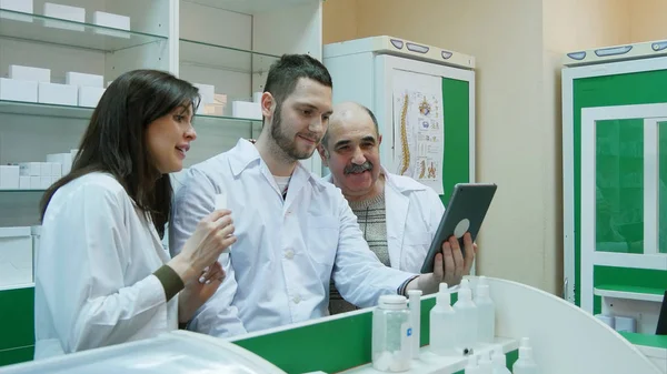 Équipe de pharmacien ayant un chat vidéo en utilisant une tablette numérique à la pharmacie — Photo