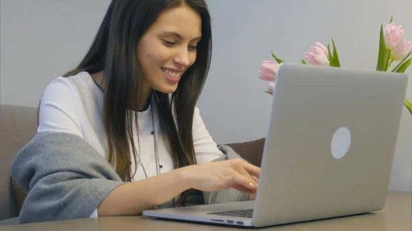 Портрет счастливого студента, работающего с ноутбуком и улыбающегося — стоковое фото