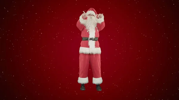 Santa posílá polibek v podobě srdce na červeném pozadí se sněhem — Stock fotografie