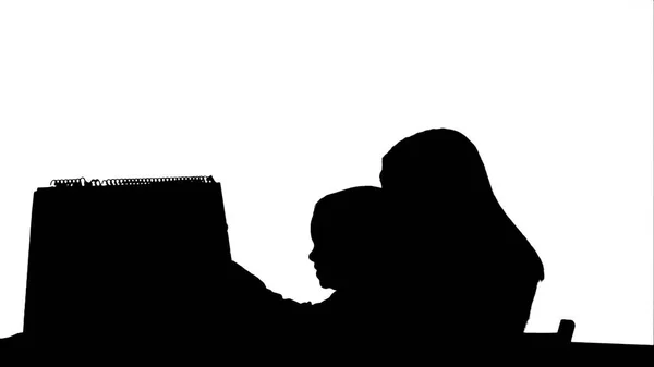 Silhouette Mother and son make word Mama on the desk — Stock Photo, Image