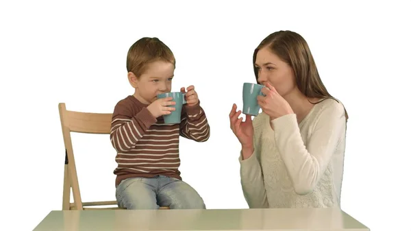 Hijo con su madre bebiendo té sobre fondo blanco aislado — Foto de Stock