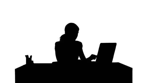 Silhouette Businesswoman working on laptop — Stock Photo, Image