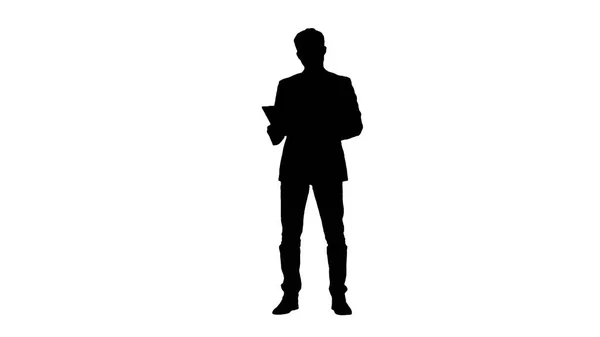 Silhouette Cool businessman using electronic tablet — Stock Photo, Image