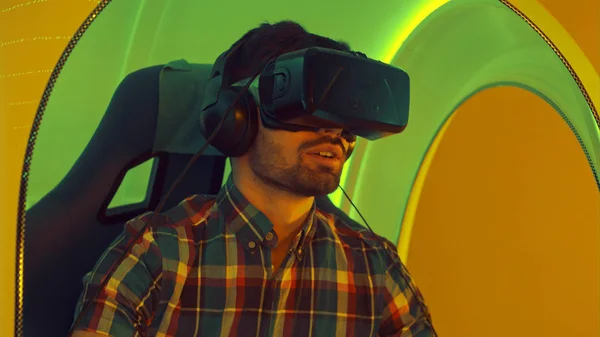 Young man enjoying virtual reality attraction