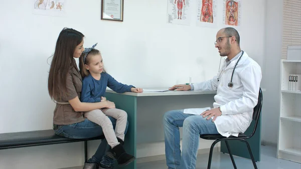 Young mother and her cute little girl having appointment with male pediatrician — Stock Photo, Image