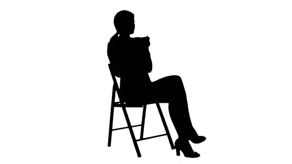 Silhouette A young attractive woman with a cup of coffee or tea on laptop — Stock Photo, Image