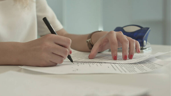 Woman using a hole puncher