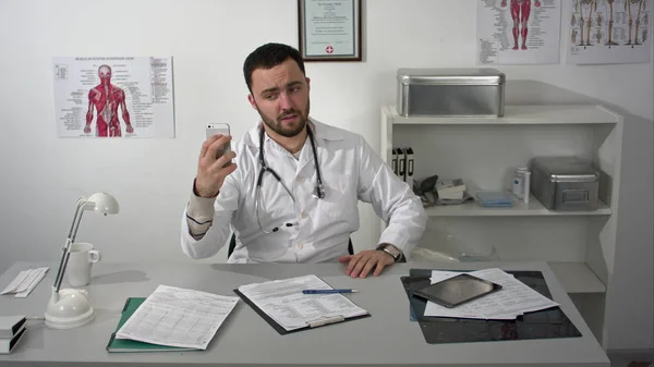 Young doctor fooling around taking selfy by phone camera — Stock Photo, Image