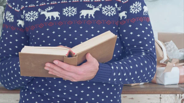 Young man holding old book in his hands — Stock Photo, Image