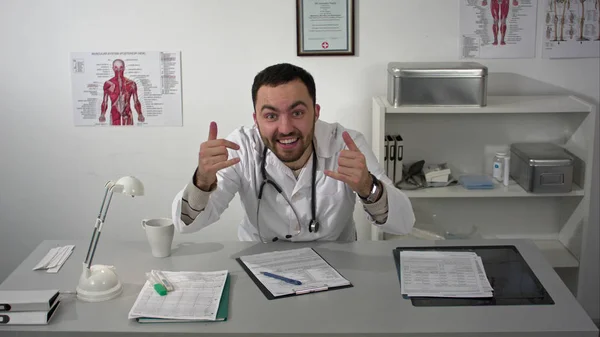 Very emotional doctor talking to camera with a lot of gestures — Stock Photo, Image