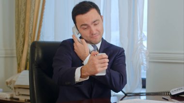 Onun smartphone tarafından komik bir selfies alarak ve bir sabit hat telefon sahip başarılı bir iş adamı
