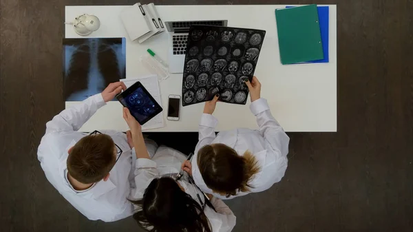 Equipo médico discutiendo el diagnóstico de imágenes de rayos X usando tabletas especiales — Foto de Stock