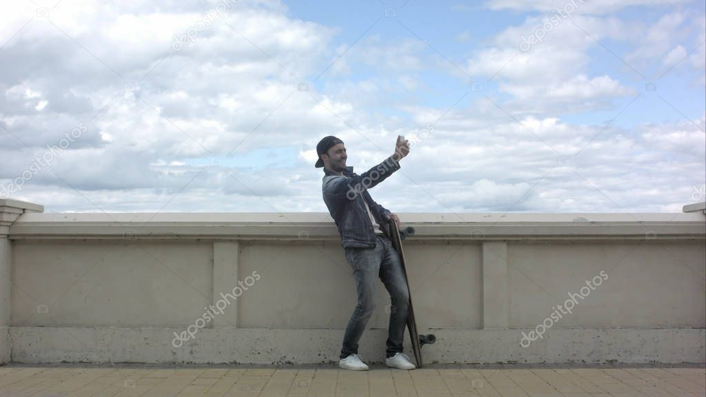 Skateboarder taking olots of selfie.