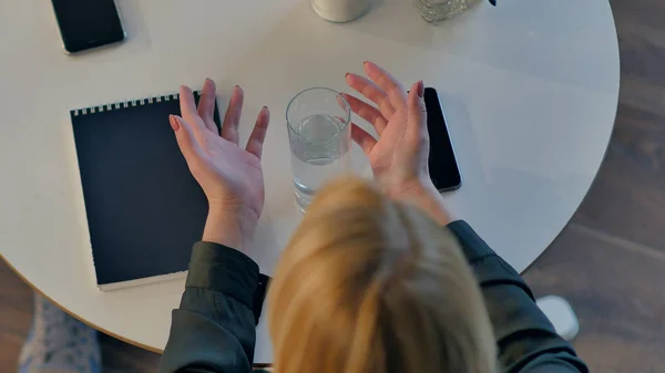 Manos femeninas sosteniendo un vaso de agua en la cafetería — Foto de Stock