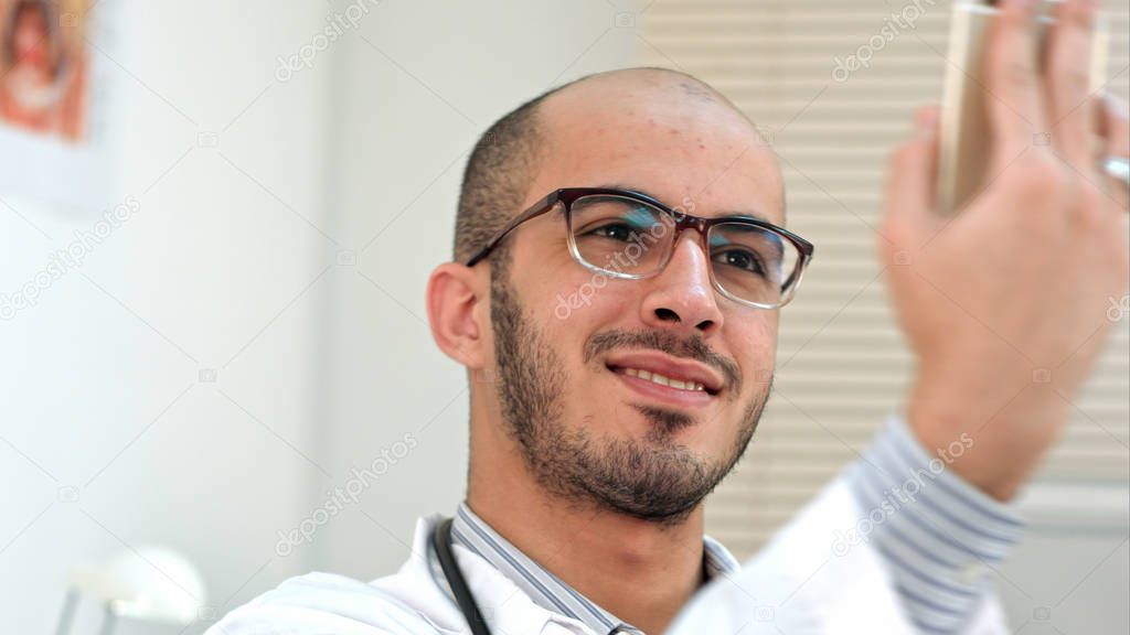 Smiling male doctor taking selfies on his phone