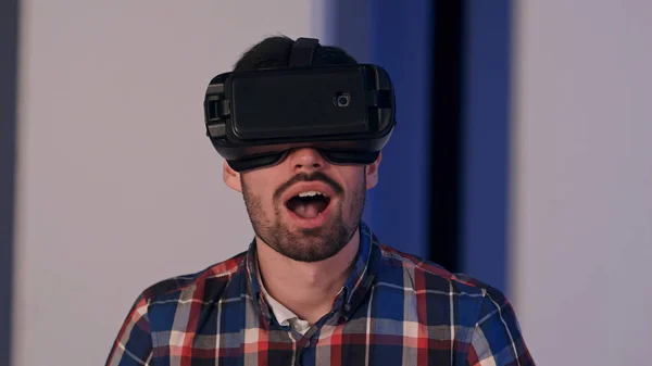 Young man putting on vr glasses and enjoying virtual reality world