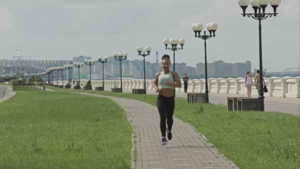 年轻女子赛跑者在城市桥梁道路上运行 — 图库视频影像