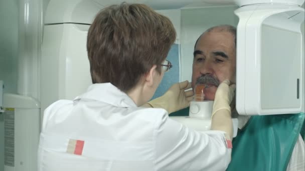 Paciente dentário sênior é submetido a varredura panorâmica do crânio dos dentes — Vídeo de Stock