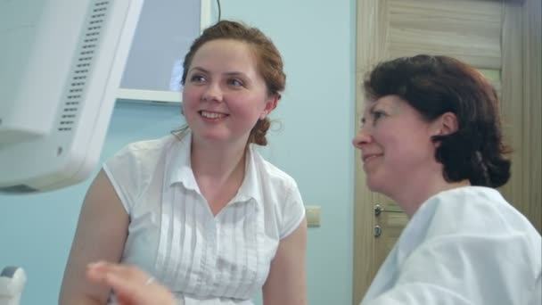 Happy smiling woman looking at her future baby on the ultrasound scan — Stock Video