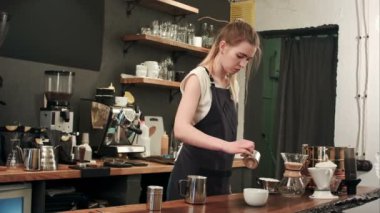 Barista dökerek kahve ve süt için bir fincan kahve dükkanında