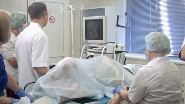 Медицинская команда, выполняющая операцию с помощью эндоскопа — стоковое видео