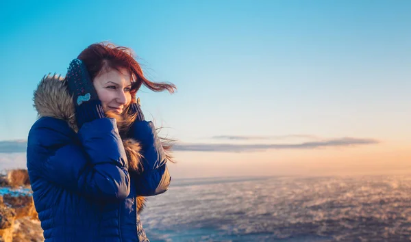 Jovem bela mulher menina desfrutando do pôr do sol no mar tempestuoso no inverno — Fotografia de Stock