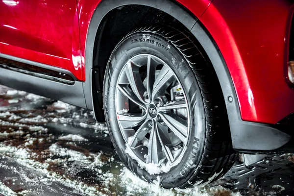 Moscow, Russia - January 2019 - Hyundai brand sports rim and tires Kumho on the stand, winter time, snow and ice — Stock Photo, Image