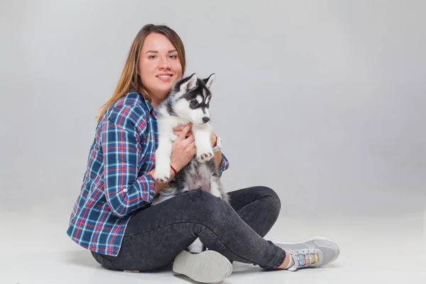 woman with puppy siberian husky