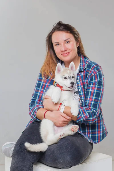 woman with puppy siberian husky