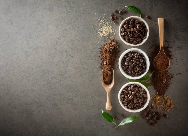 Kahve çekirdekleri şeker ve karanlık vintage zemin üzerine yeşil yaprak ile farklı çeşitleri. Üstten Görünüm