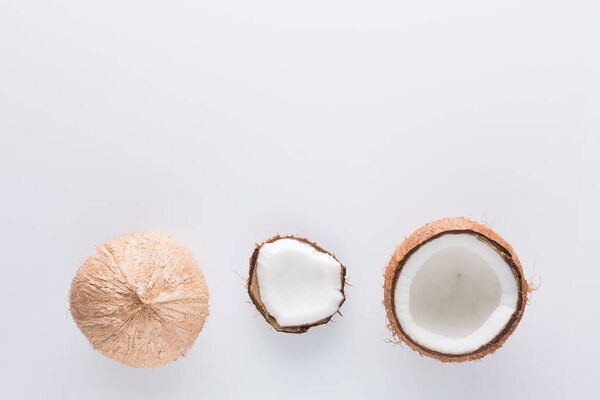 Tropical fruit whole and half abstract background .Coconut on white background. from top view