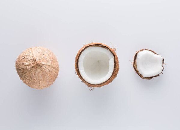 Tropical fruit whole and half abstract background .Coconut on white background. from top view
