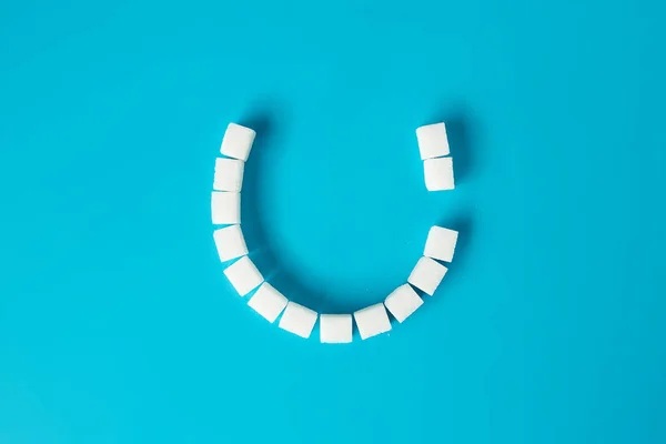 Smiling Face Tooth Decay Made Sugar Cubes Blue Background Sugar — Stock Photo, Image