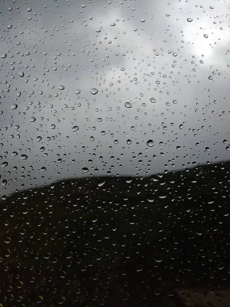 Water drops on the glass after the rain. Blurred background photo