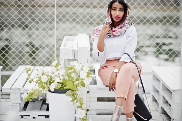 Beyaz bluz ve şeftali pantolon Arap kız moda açık poz verdi. Şık Müslüman kadın.