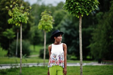 Yeşil pantolon ve siyah şapka Parkı'nda yarattığı inanılmaz bir Afro-Amerikan modeli kadın.