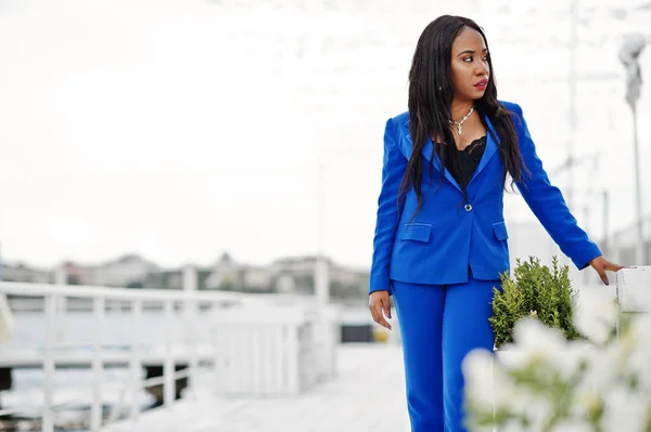 Success african american business woman at blue suit posed.